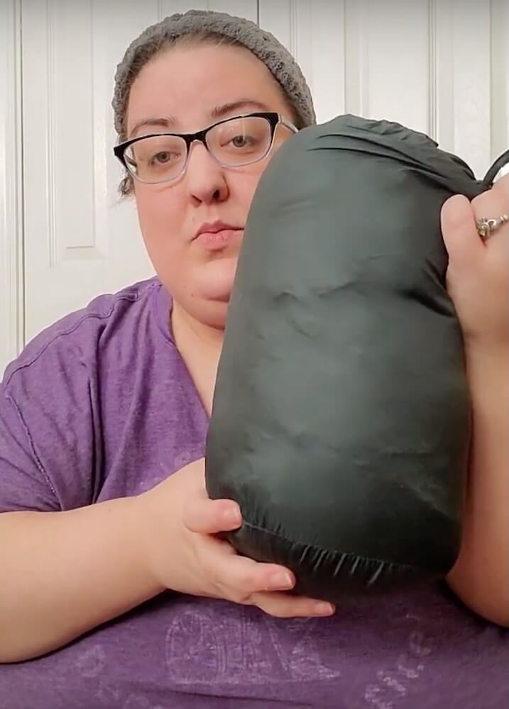 Close up of the jacket in its carrying case, being held up by Ericka.