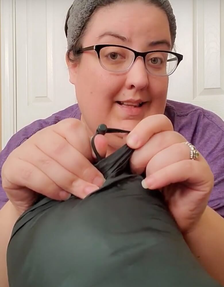 Close up of the draw string of the jacket carrying case, which can be hooked onto the back of a wheelchair or a backpack.
