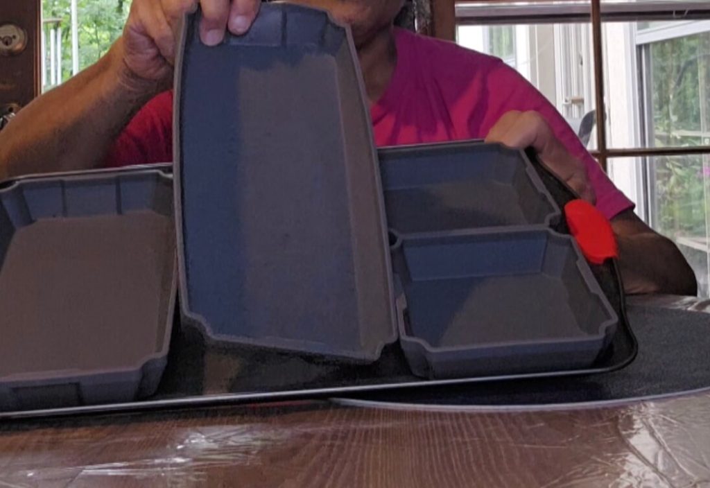 Karen holding up one of the silicone pans with just a few fingers.
