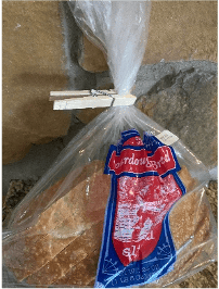 A clothespin is holding the top of a plastic bread bag shut.